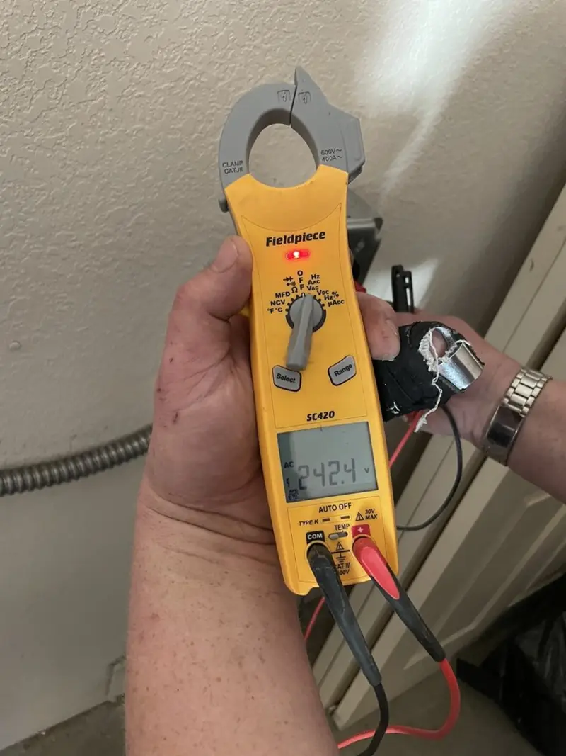 Voltage testing with clamp meter during Ceiling Fan Installation in Golden Beach